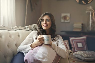 Ceramic mug in the hand of brunette woman