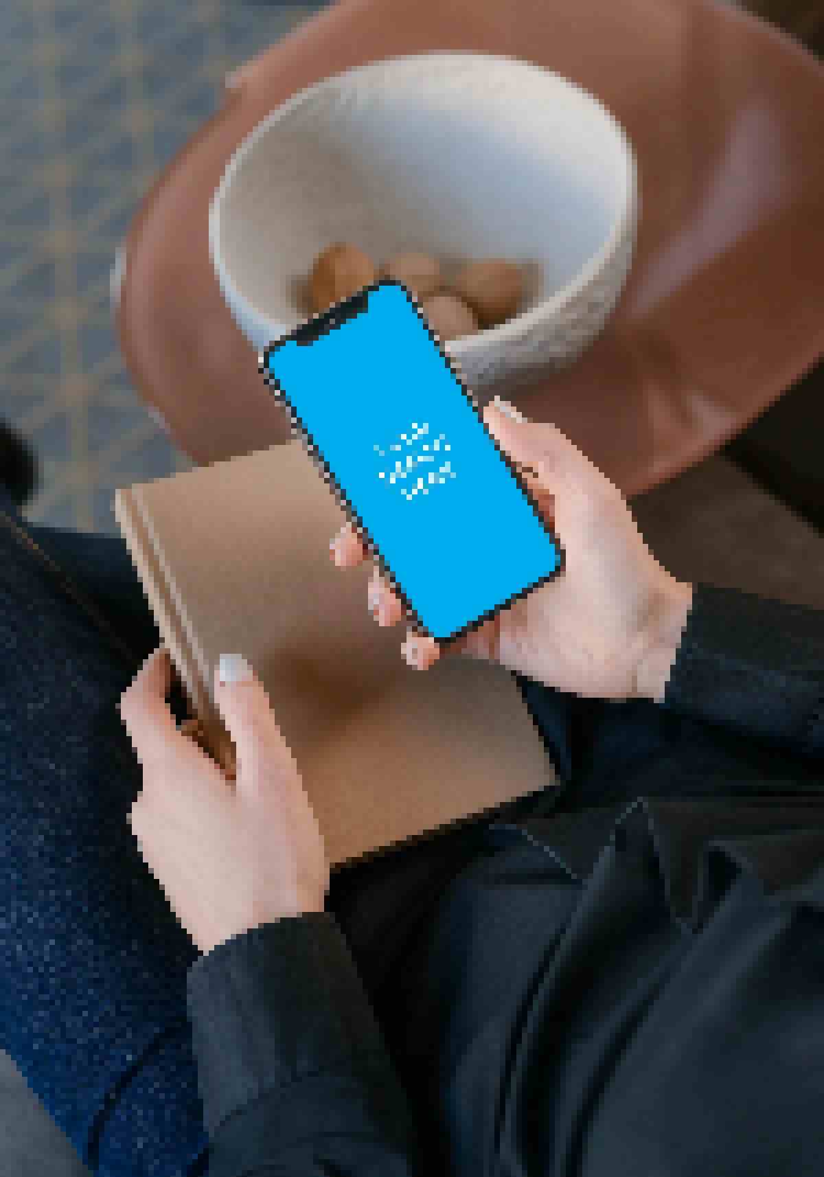 iPhone 11 and the book in the hand of a woman