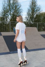 Woman wearing a T-shirt in a skatepark - back view